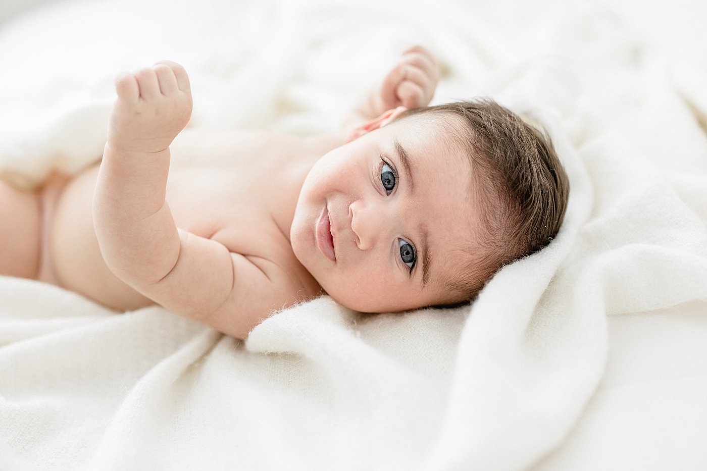 Professional caregiver holding a newborn baby in a bright, modern facility